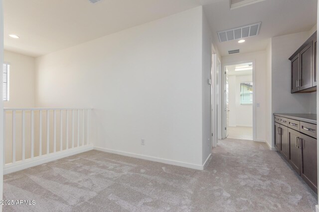 empty room featuring light colored carpet