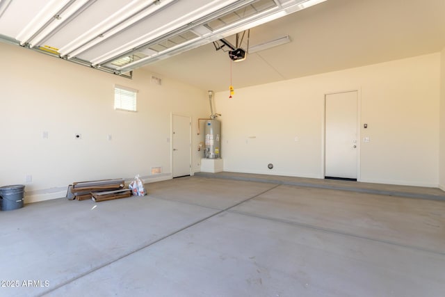 garage featuring water heater and a garage door opener