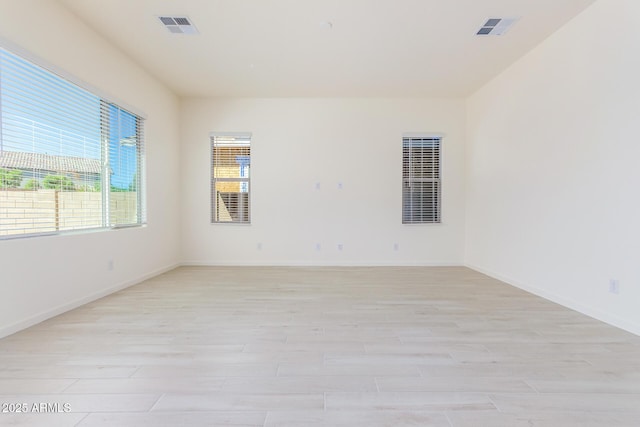 empty room with light hardwood / wood-style flooring