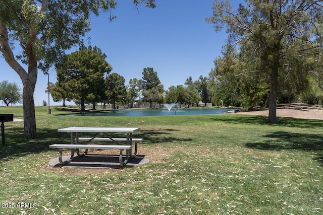 surrounding community featuring a water view and a yard