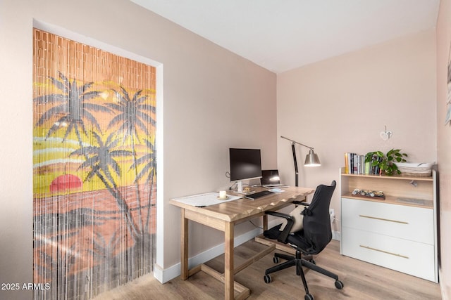 home office with wood finished floors and baseboards