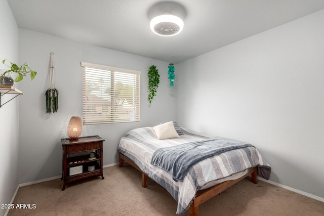 bedroom with light carpet and baseboards