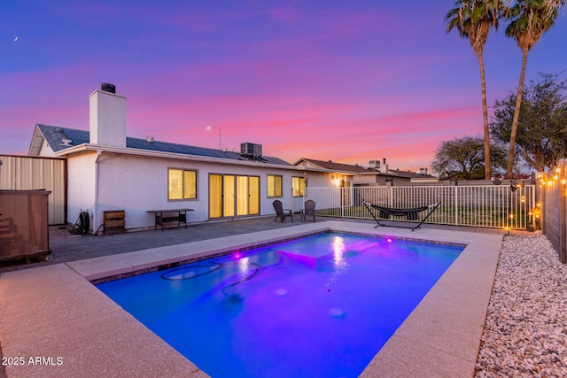 view of pool featuring a patio area, a fenced backyard, cooling unit, and a fenced in pool