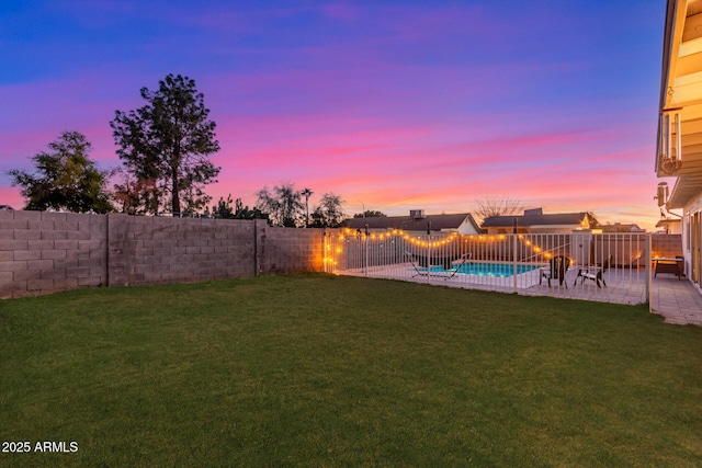 yard at dusk featuring a patio, a fenced backyard, and a fenced in pool