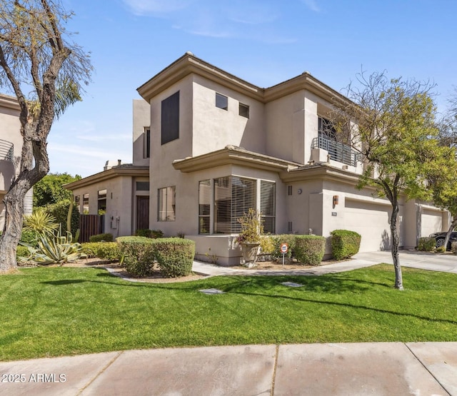 mediterranean / spanish-style house with a front yard, a balcony, and stucco siding