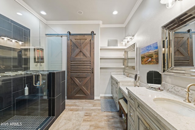 full bath with ornamental molding, a stall shower, two vanities, and a sink