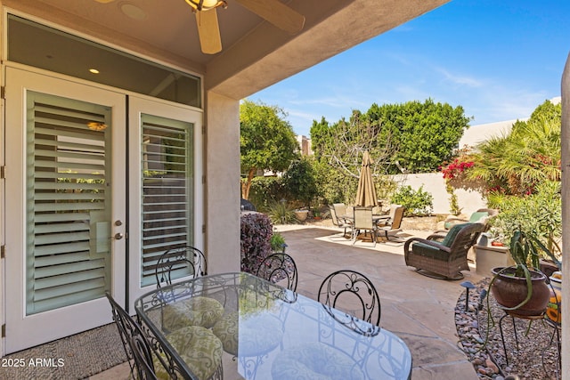 view of patio / terrace with outdoor dining space, ceiling fan, and fence