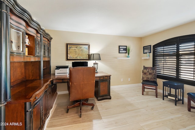 home office with light hardwood / wood-style floors