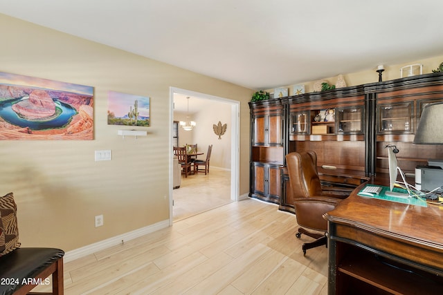 home office with light hardwood / wood-style flooring