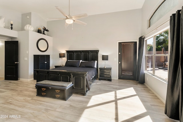 bedroom with high vaulted ceiling, ceiling fan, and light hardwood / wood-style flooring