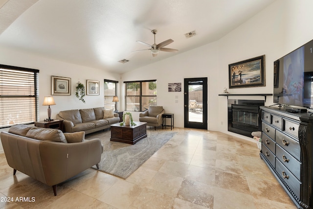 living room with ceiling fan and vaulted ceiling