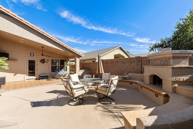 view of patio featuring exterior fireplace