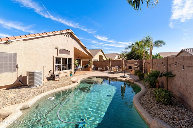 view of swimming pool featuring central AC unit and a patio area