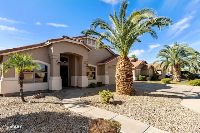 mediterranean / spanish-style home with a garage