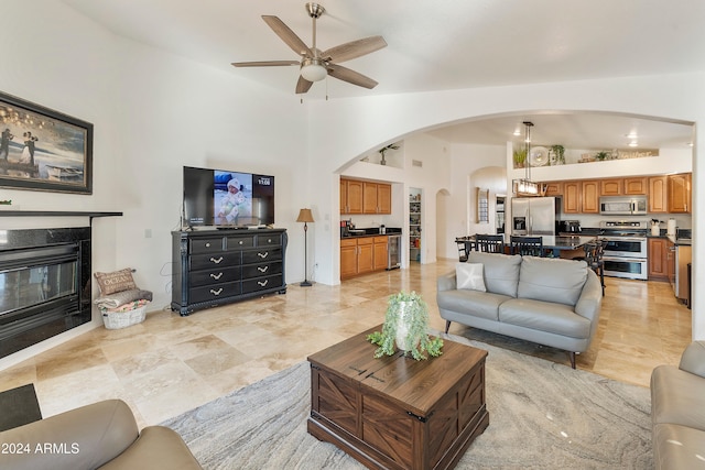 living room featuring high vaulted ceiling and ceiling fan