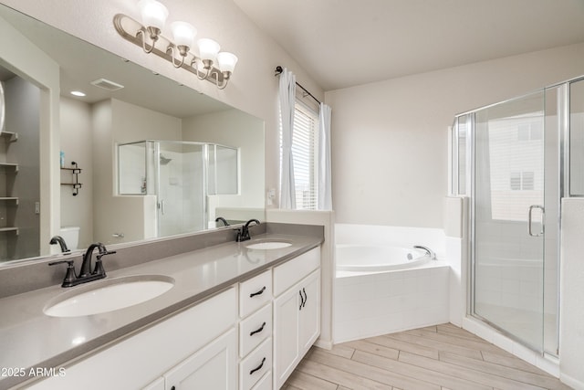 bathroom featuring shower with separate bathtub and vanity