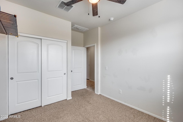 unfurnished bedroom with light carpet, a closet, and ceiling fan