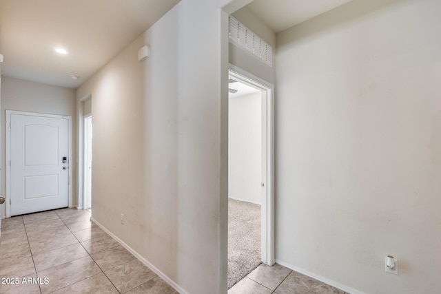 hall with light tile patterned floors