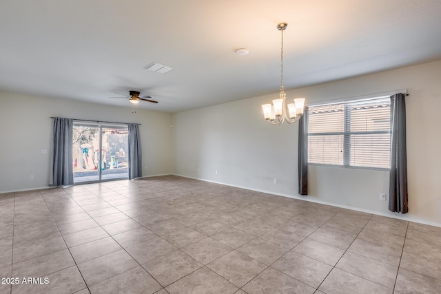 spare room with ceiling fan with notable chandelier and light tile patterned floors