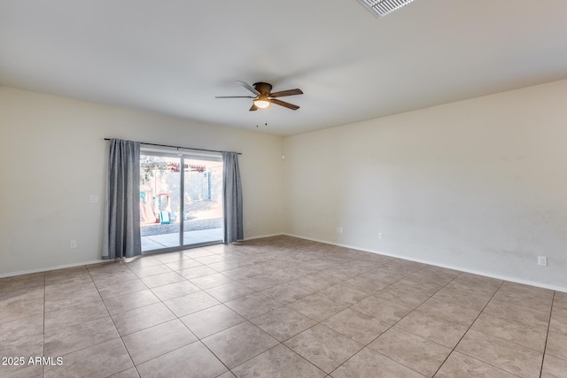 empty room with light tile patterned floors and ceiling fan