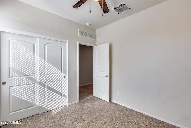 unfurnished bedroom with carpet floors, a closet, and ceiling fan