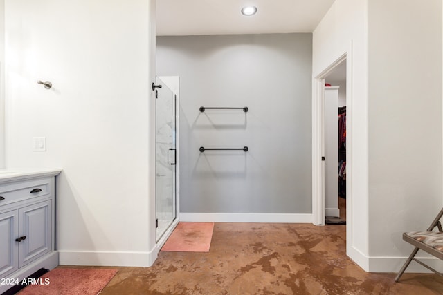 bathroom with vanity and a shower with door