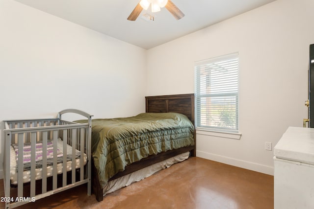 bedroom featuring ceiling fan and concrete floors