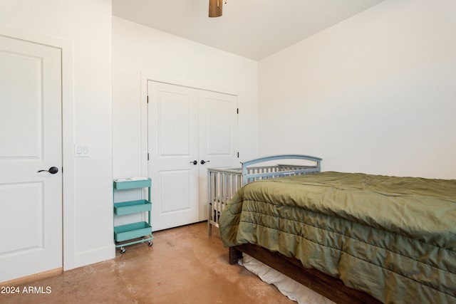 bedroom featuring a closet, concrete floors, and ceiling fan