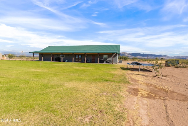 exterior space featuring a mountain view and a yard