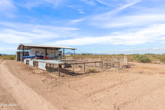 view of yard featuring a rural view and an outdoor structure