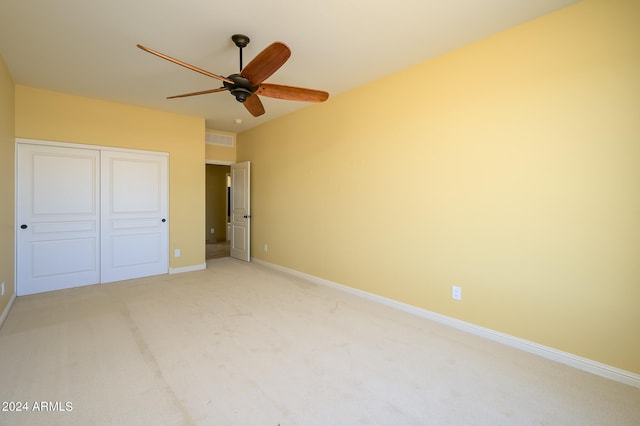 unfurnished bedroom featuring a closet, ceiling fan, and carpet