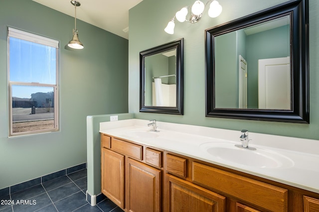 full bathroom featuring double vanity, a sink, and tile patterned flooring