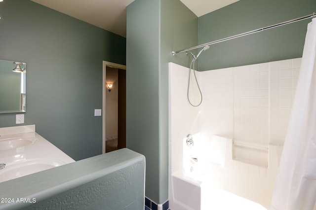 full bathroom with a sink, shower / bath combo with shower curtain, and double vanity