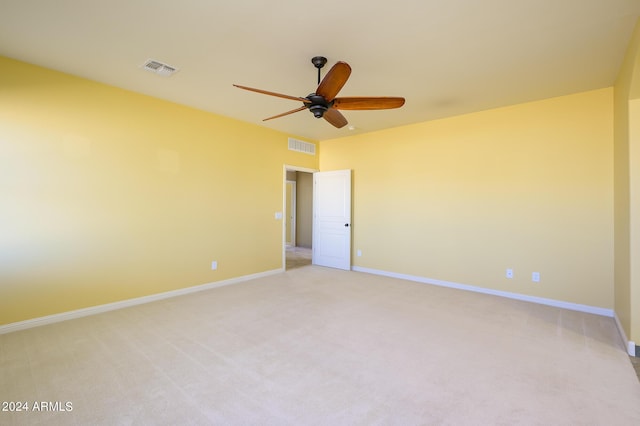 empty room featuring visible vents, baseboards, ceiling fan, and light carpet