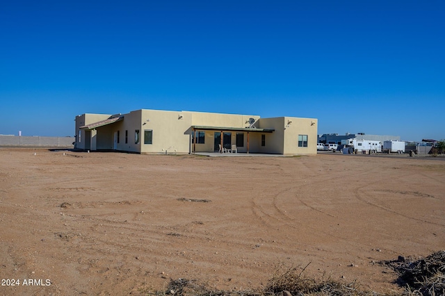 rear view of property with stucco siding