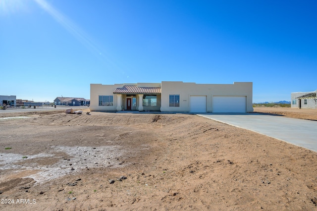 pueblo-style house with a garage