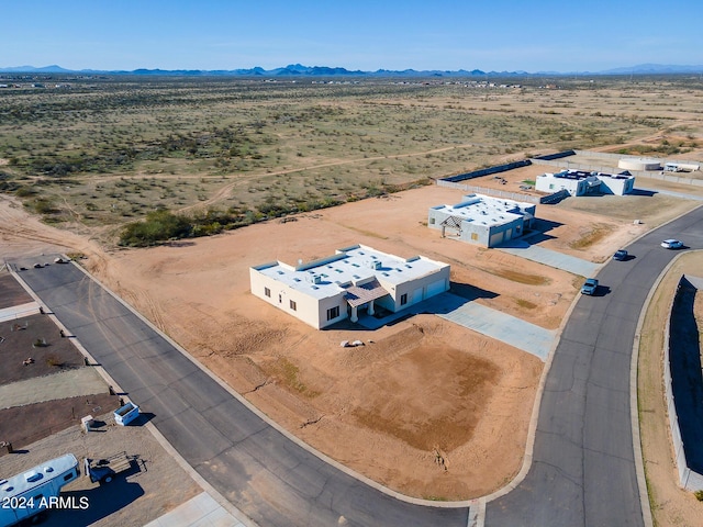 drone / aerial view with view of desert, a mountain view, and a rural view