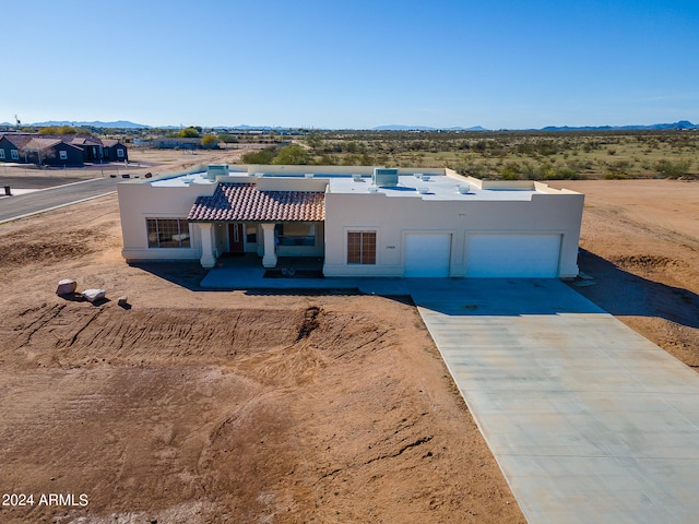 view of front of home with a mountain view and a garage