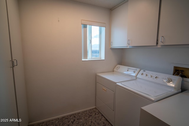 washroom featuring cabinets and washing machine and clothes dryer