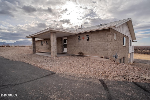 view of front of house featuring a mountain view and a patio