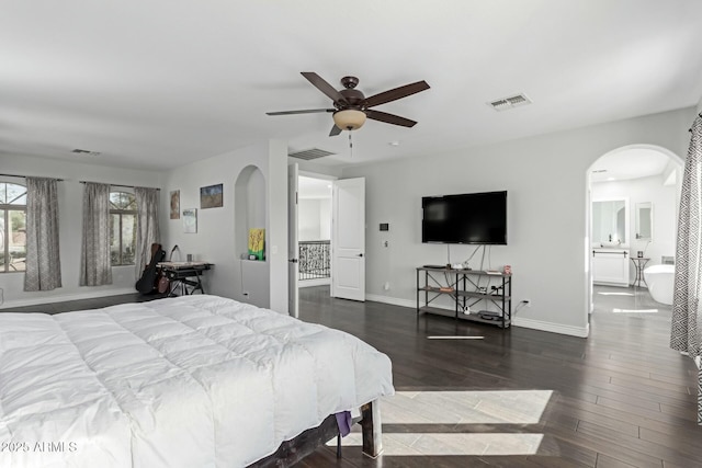 4497 E Carriage Way, Gilbert, AZ 85297 - bedroom featuring arched walkways, wood finished floors, baseboards, connected bathroom, and a ceiling fan