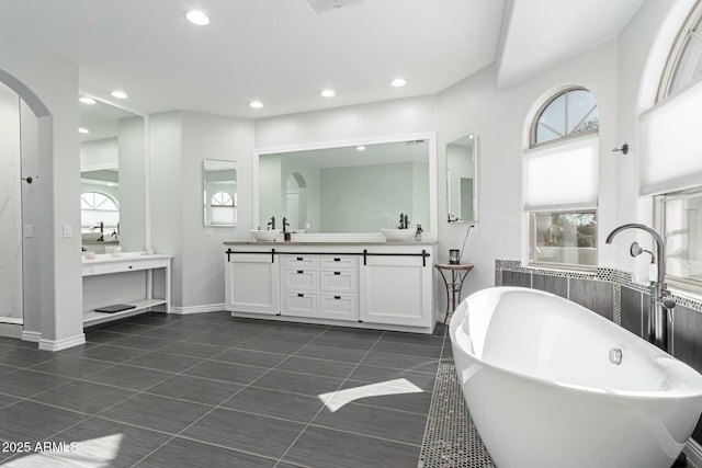4497 E Carriage Way, Gilbert, AZ 85297 - full bath with a soaking tub, two vanities, plenty of natural light, tile patterned flooring, and recessed lighting