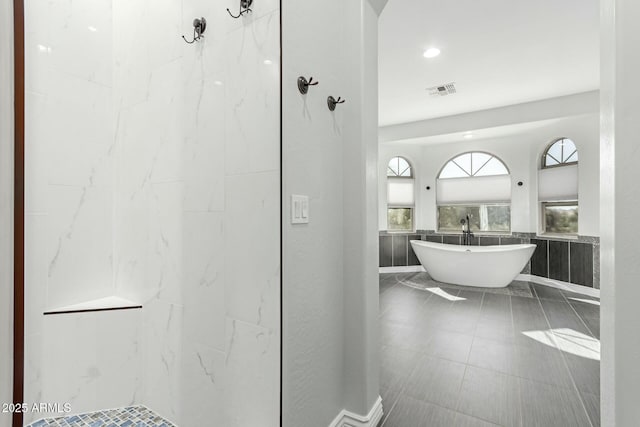 4497 E Carriage Way, Gilbert, AZ 85297 - bathroom featuring a soaking tub and a shower