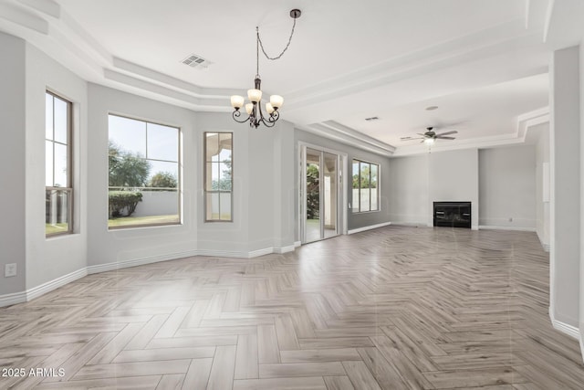 4497 E Carriage Way, Gilbert, AZ 85297 - unfurnished living room with a tray ceiling, a chandelier, a glass covered fireplace, and baseboards