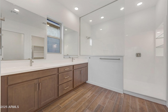 bathroom featuring vanity and a shower