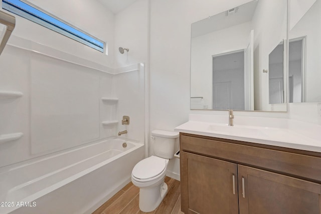 full bathroom with vanity, bathing tub / shower combination, toilet, and hardwood / wood-style floors