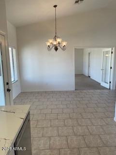 unfurnished dining area with brick patterned floor and a chandelier