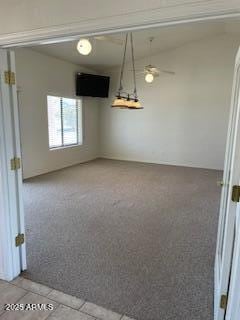 unfurnished dining area with carpet floors, ceiling fan, and tile patterned floors