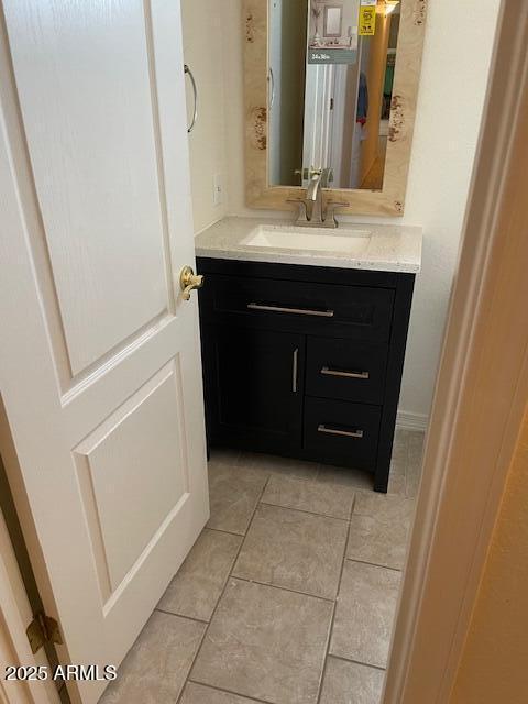 bathroom featuring tile patterned flooring and vanity
