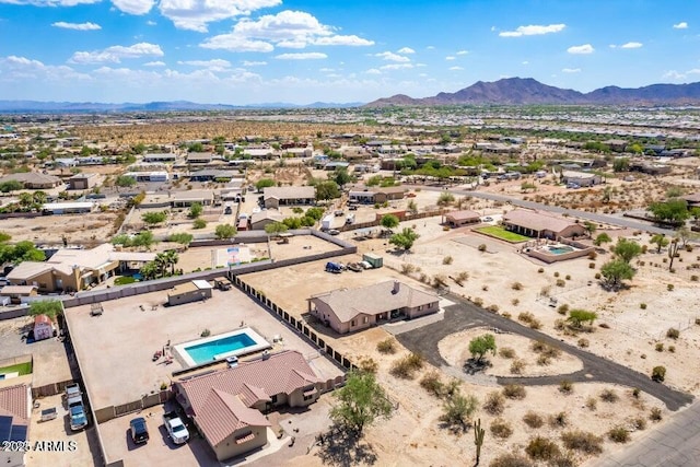 aerial view featuring a residential view, a mountain view, and a desert view